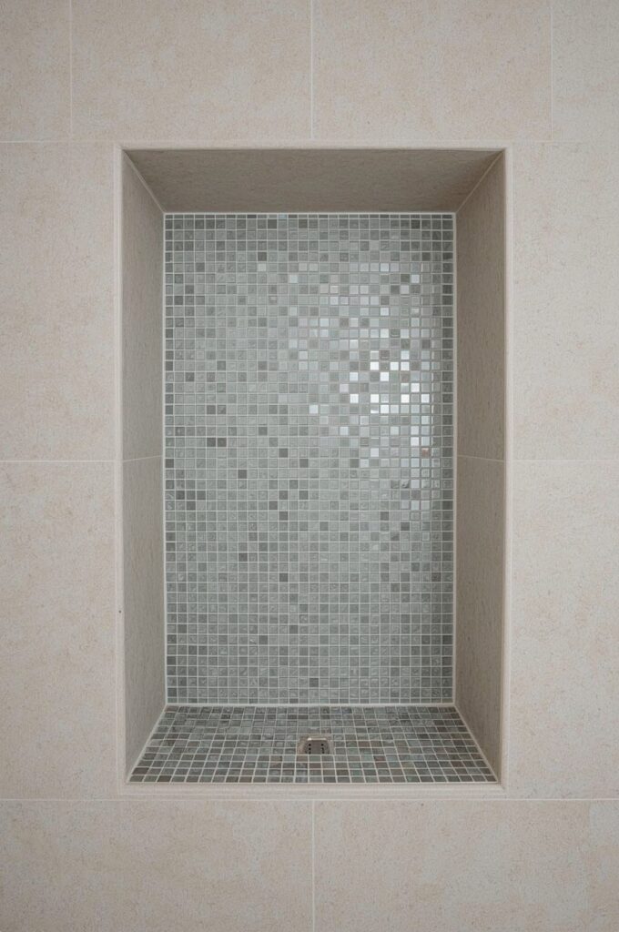 Small Glass Mosaic Tiles in Shower Niche