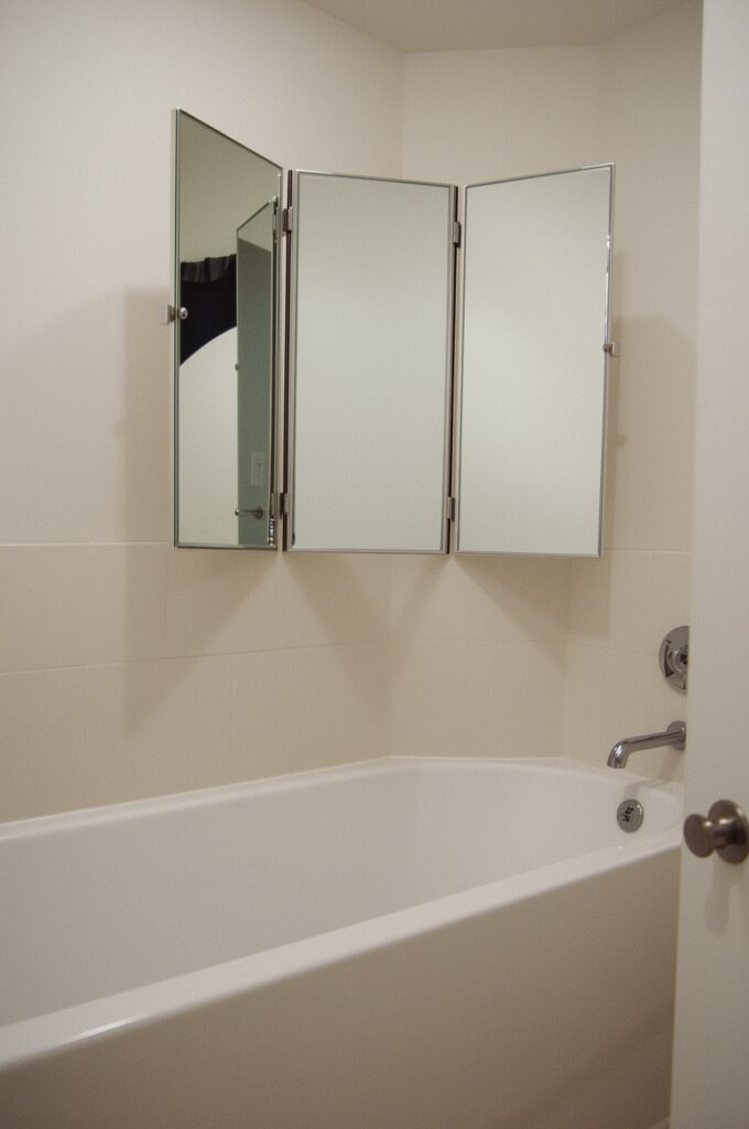 Tub with Folding Vanity Mirror Above